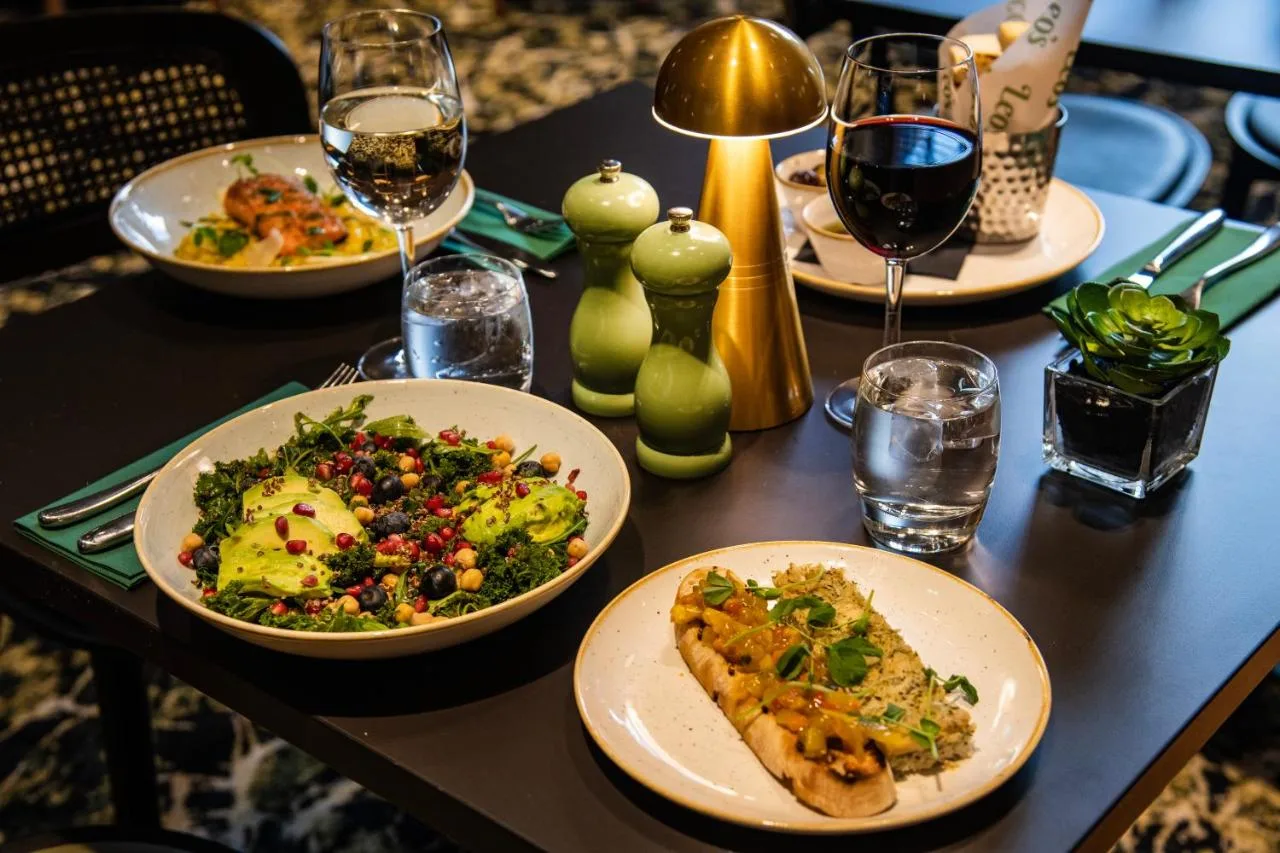Table with plates of food and glasses of wine at the Birmingham hotel restaurant