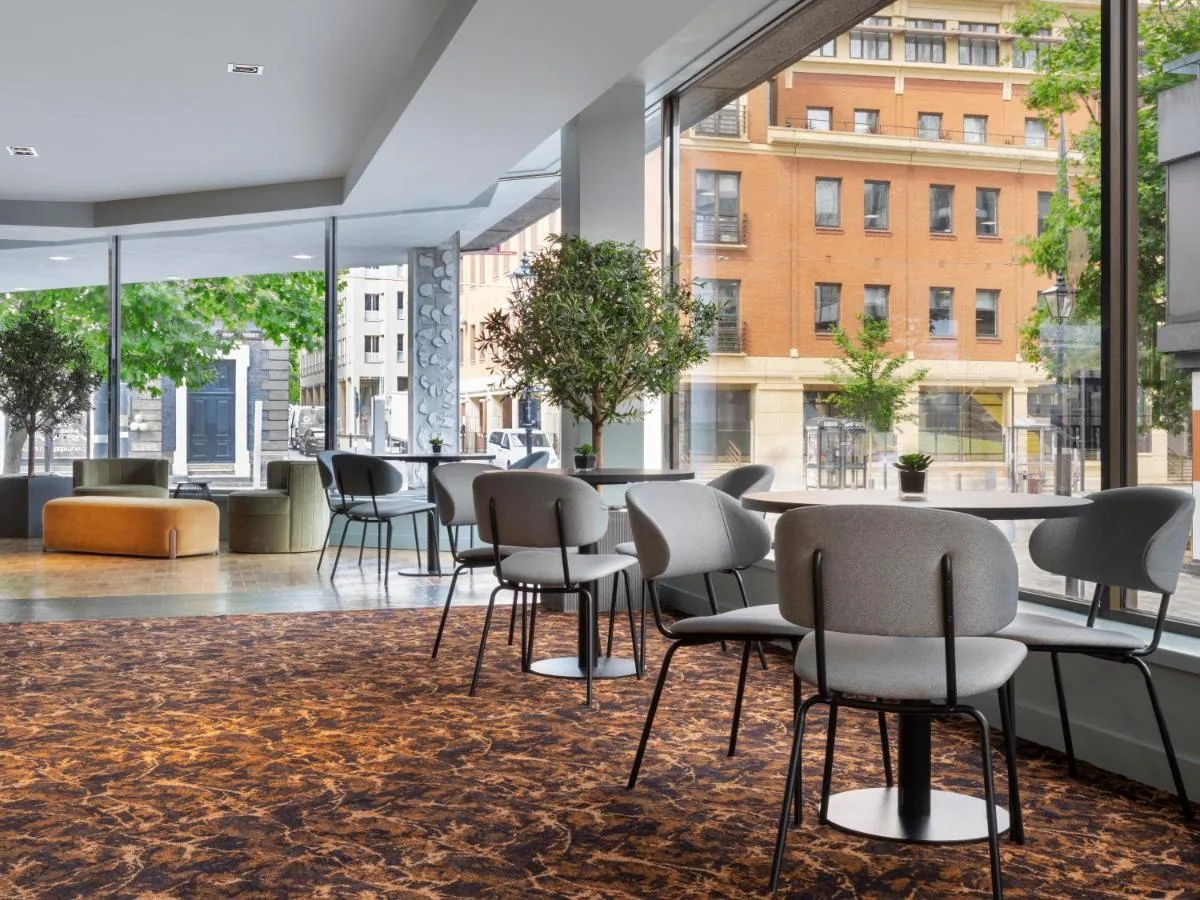 Bright lounge room with windows and seating at Leonardo Royal Hotel Birmingham